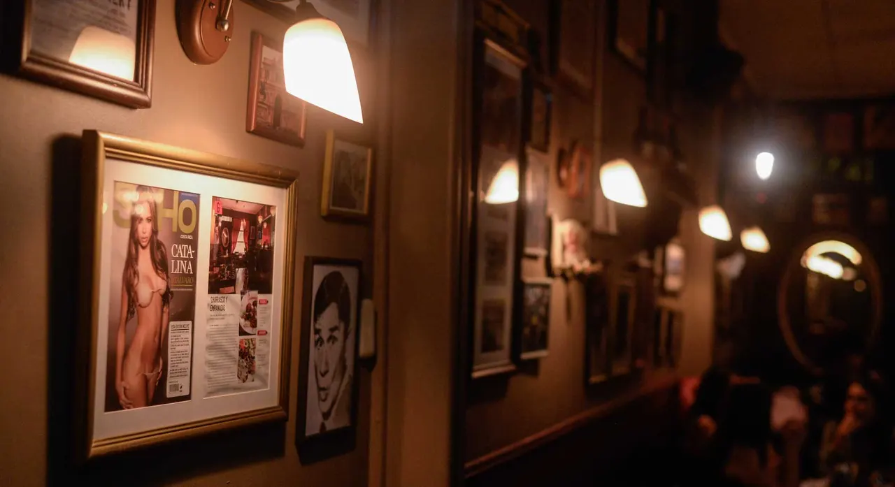 Pasillo del restaurante con luces cálidas y fotografías enmarcadas