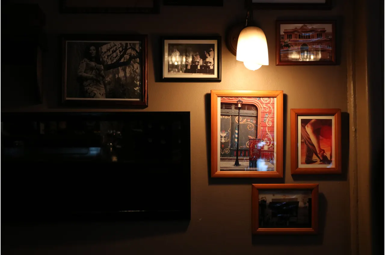 Detalle de cuadros iluminados sobre una pared